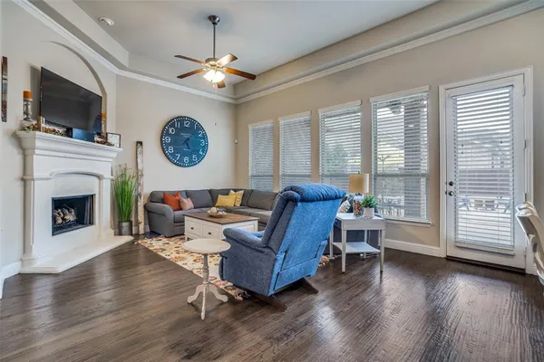 a living room with furniture a fireplace and a flat screen tv