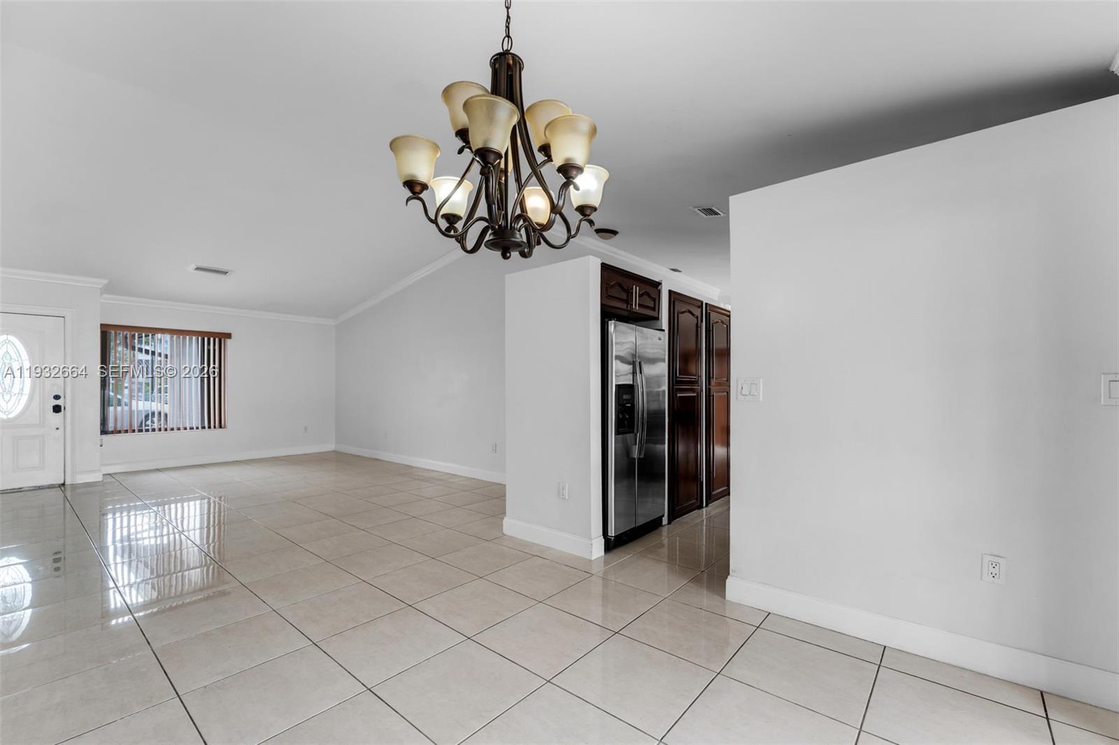 10290 Southwest 145th Place Miami, FL 33186 - Photo 11 of 50 a view of a hallway with a chandelier