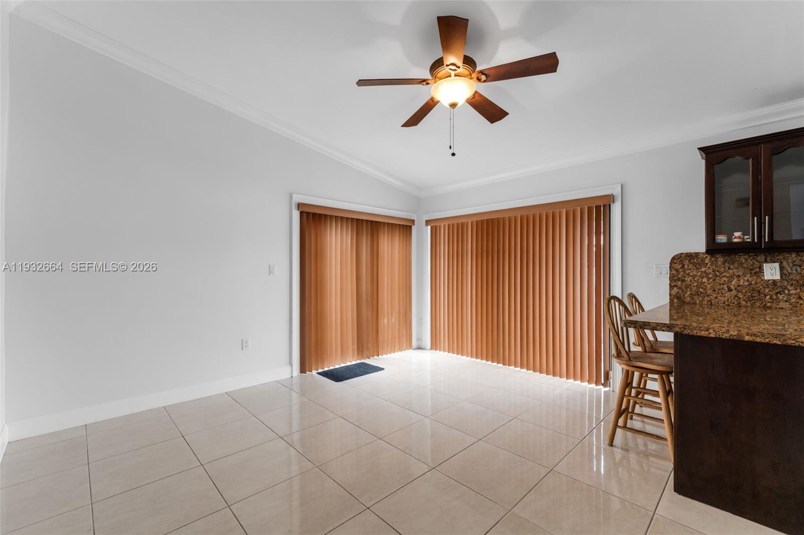 10290 Southwest 145th Place Miami, FL 33186 - Photo 13 of 50 a bedroom with a bed and a chandelier