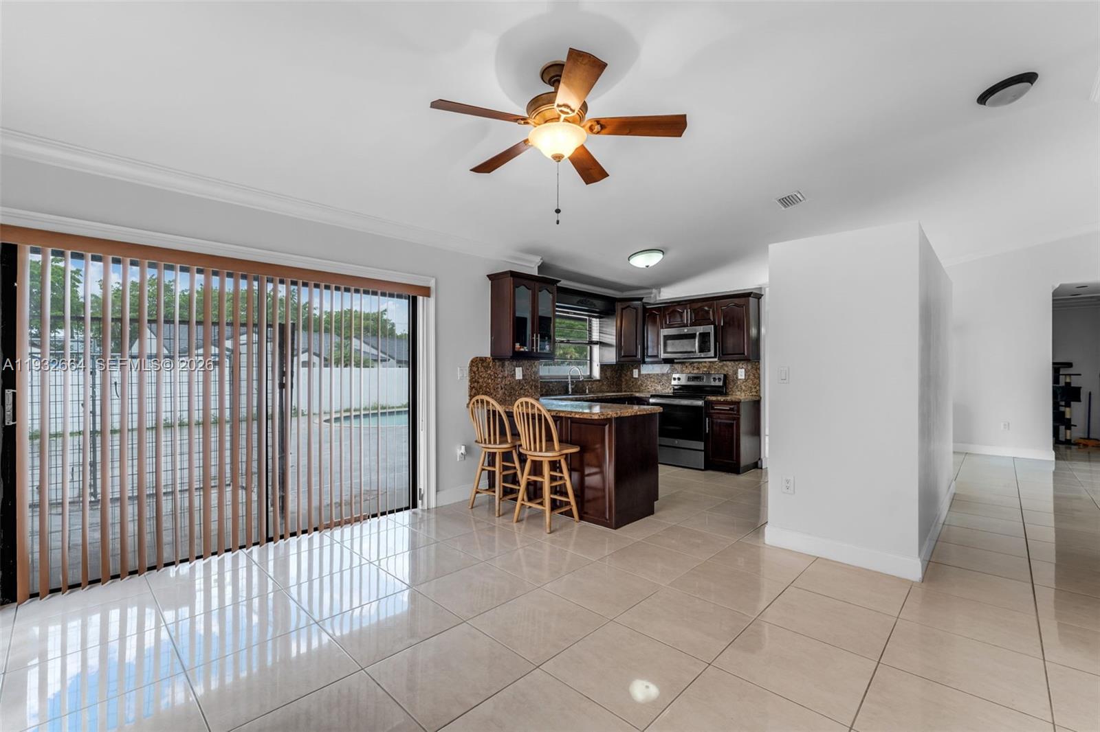 10290 Southwest 145th Place Miami, FL 33186 - Photo 14 of 50 a view of a kitchen with furniture and a stove