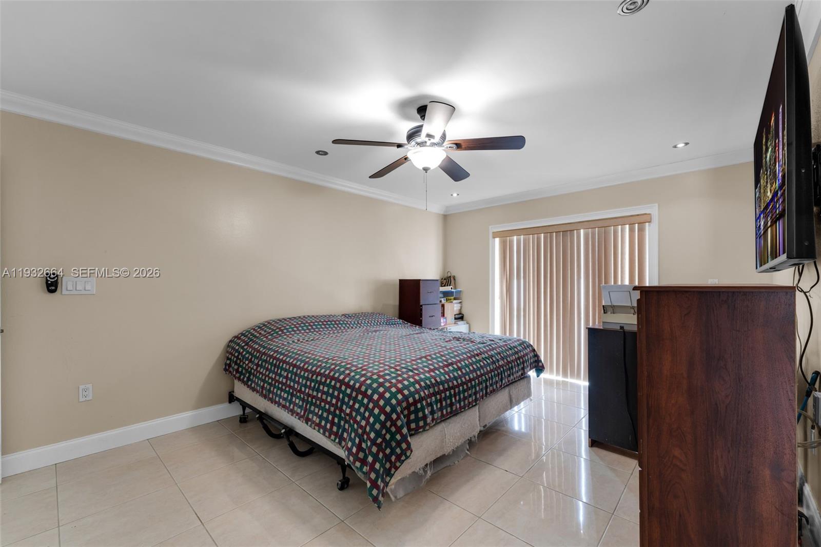 10290 Southwest 145th Place Miami, FL 33186 - Photo 19 of 50 a bedroom with a bed and a chandelier