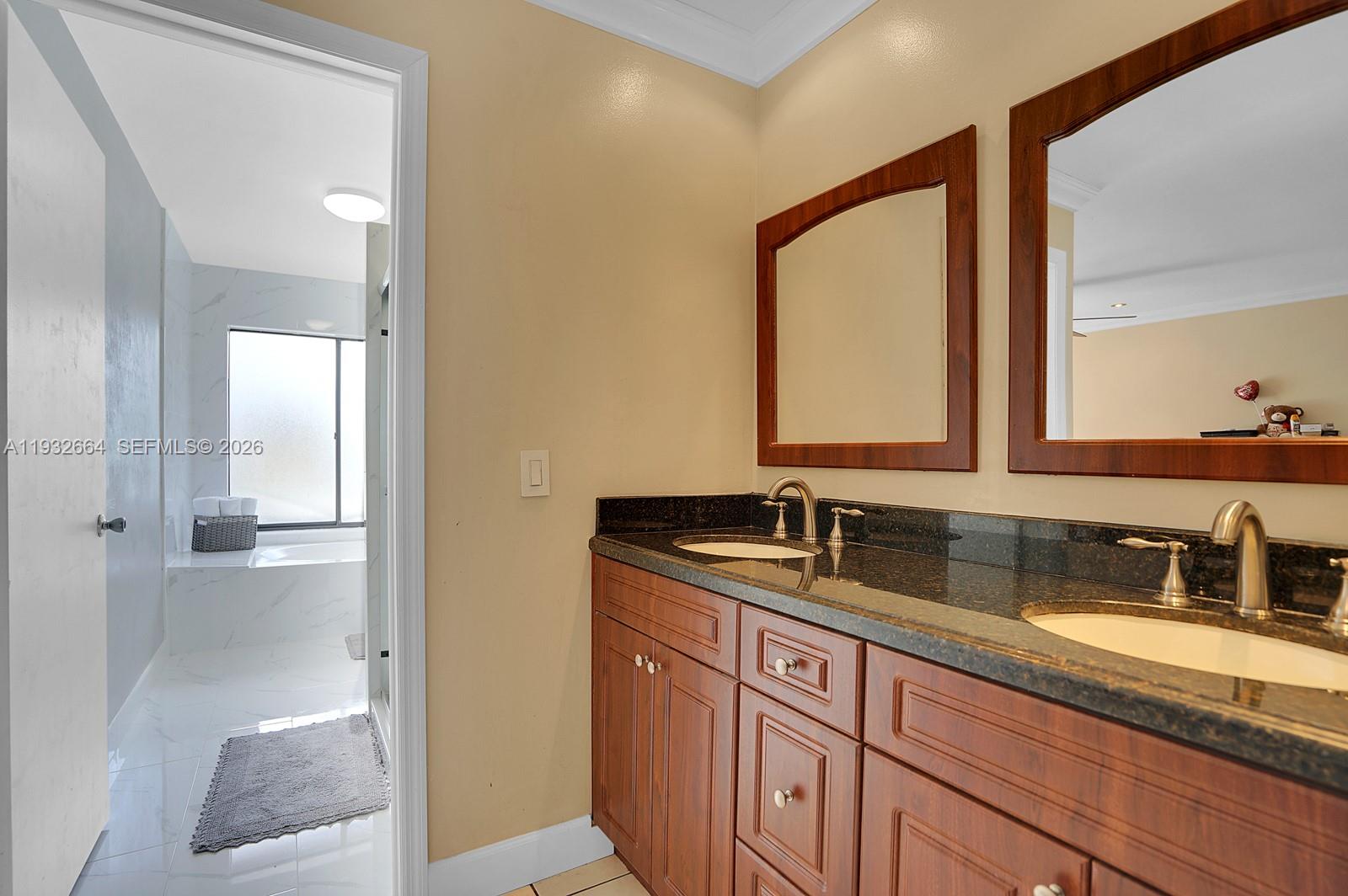 10290 Southwest 145th Place Miami, FL 33186 - Photo 21 of 50 a bathroom with a sink and a mirror