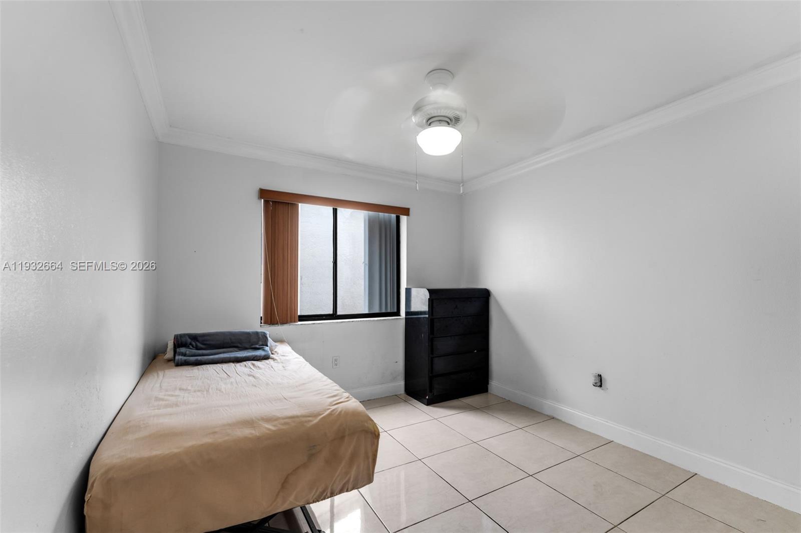 10290 Southwest 145th Place Miami, FL 33186 - Photo 24 of 50 a bedroom with a bed and a table
