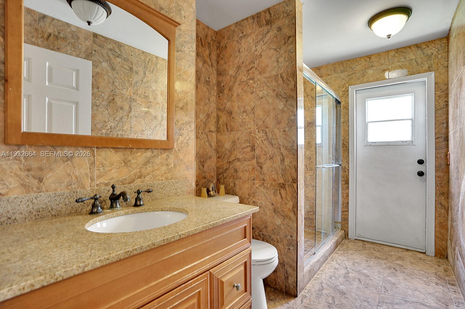10290 Southwest 145th Place Miami, FL 33186 - Photo 25 of 50 a bathroom with a sink and a mirror