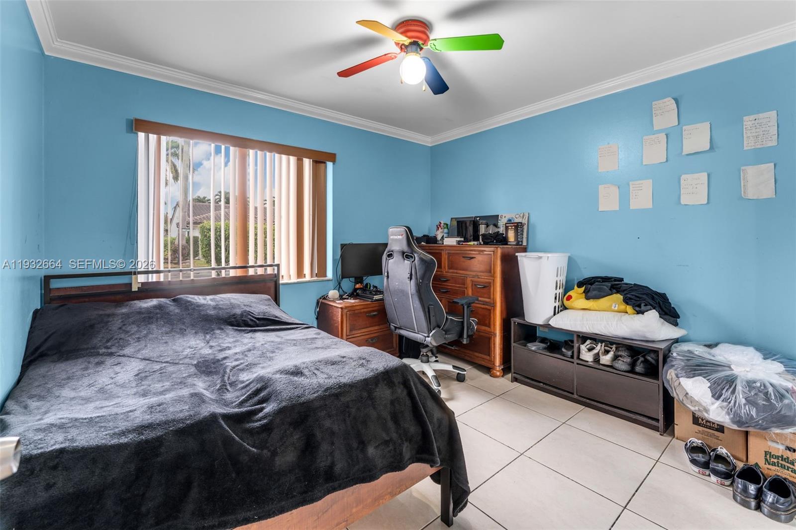 10290 Southwest 145th Place Miami, FL 33186 - Photo 26 of 50 a bedroom with a bed and a chandelier