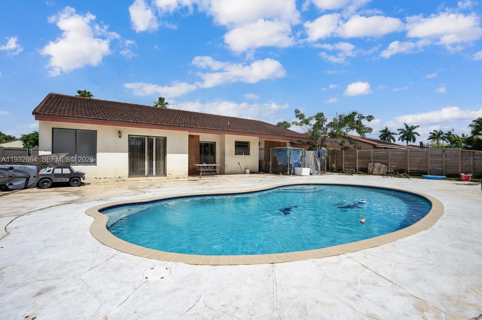 10290 Southwest 145th Place Miami, FL 33186 - Photo 29 of 50 a view of outdoor space yard swimming pool and fire pit