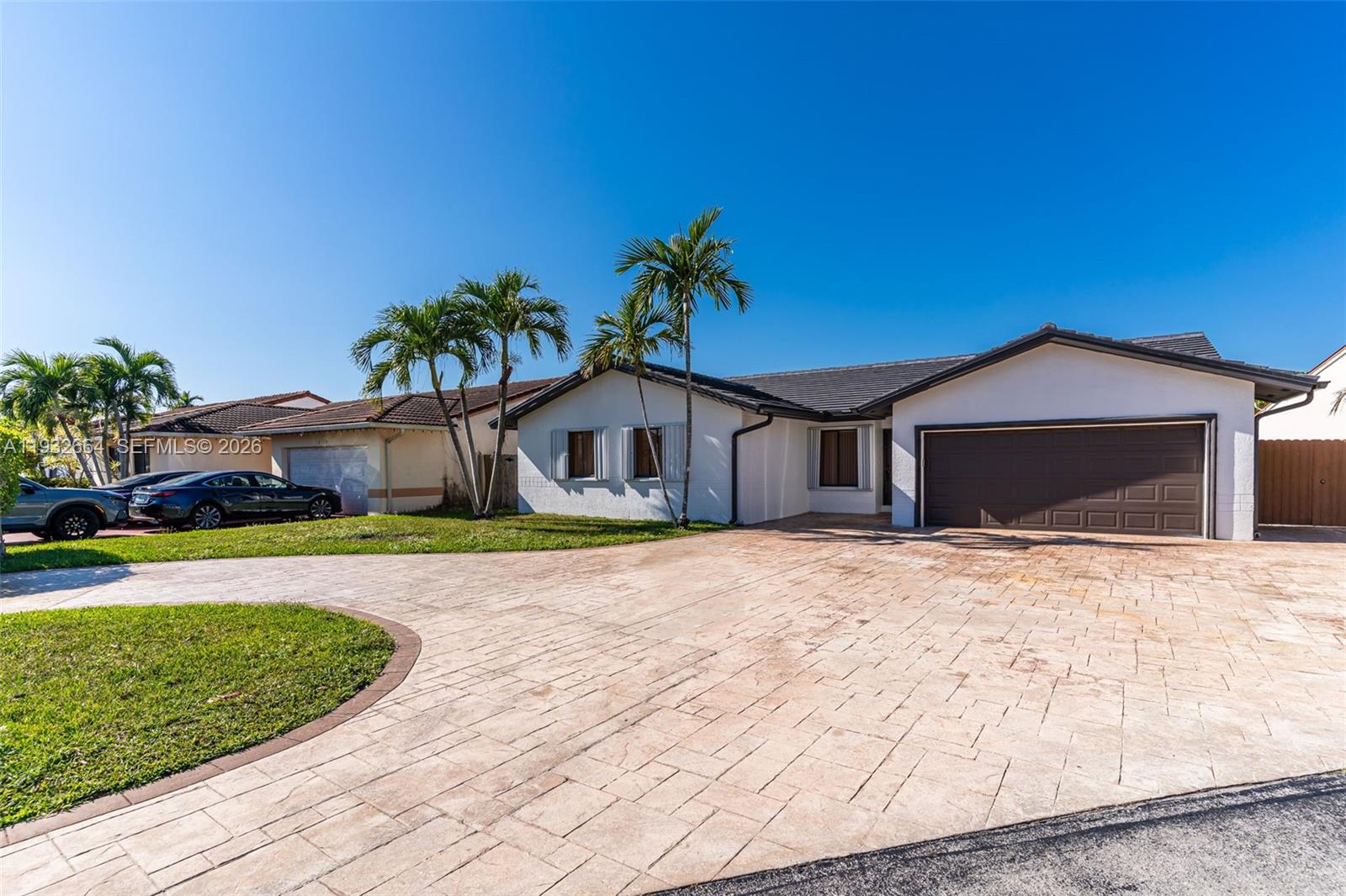 10290 Southwest 145th Place Miami, FL 33186 - Photo 4 of 50 a front view of a house with a yard and garage