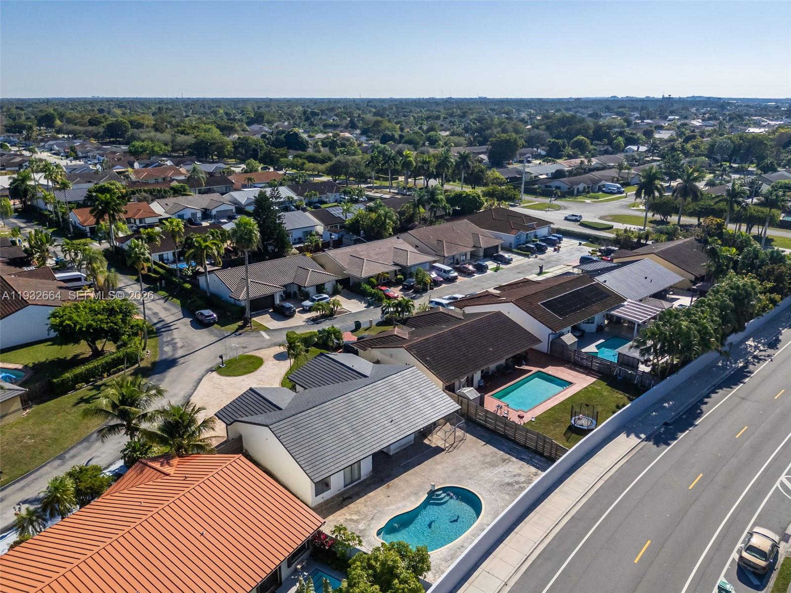 10290 Southwest 145th Place Miami, FL 33186 - Photo 42 of 50 an aerial view of a house with a swimming pool outdoor seating and yard
