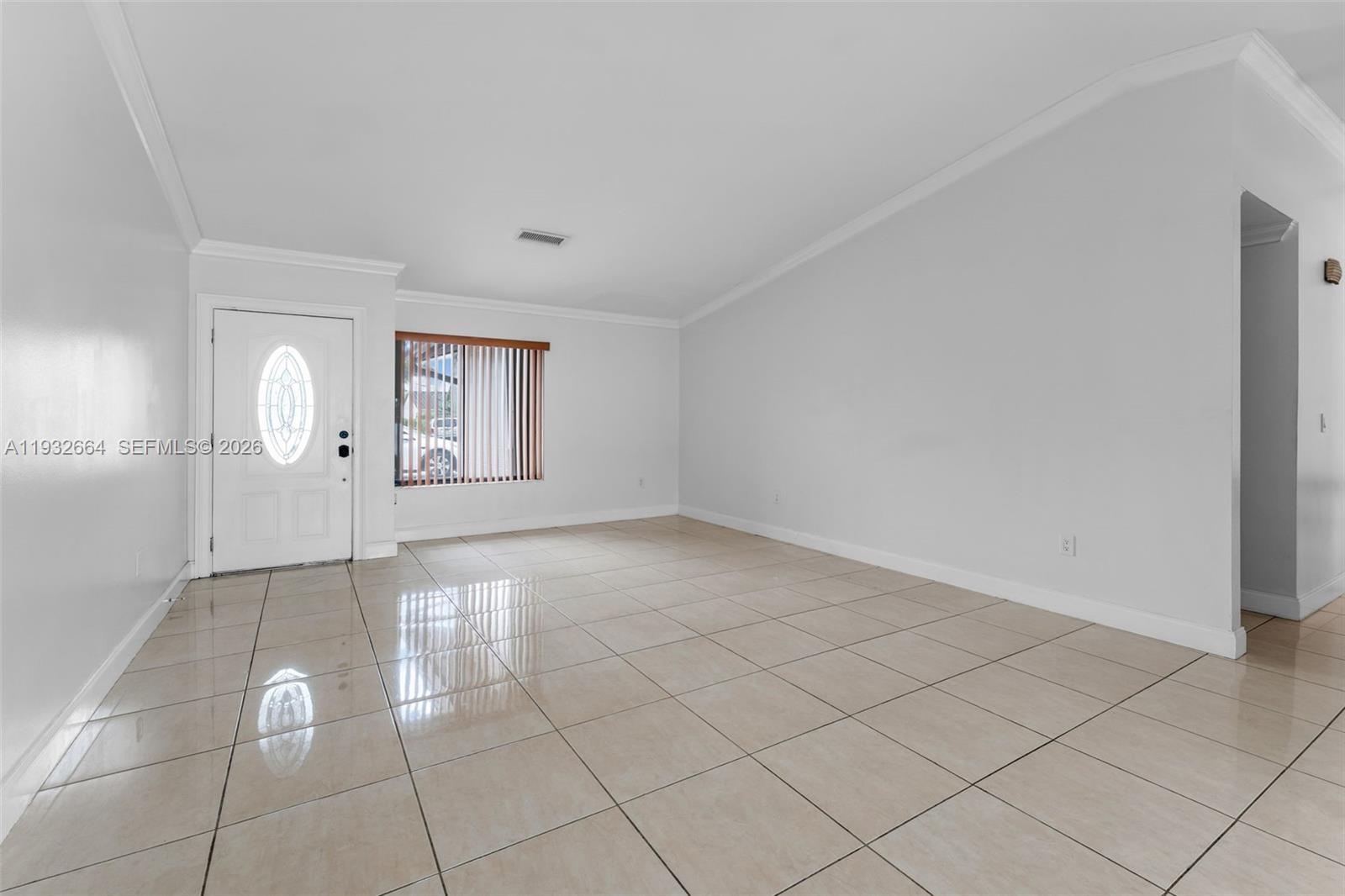 10290 Southwest 145th Place Miami, FL 33186 - Photo 10 of 50 an empty room with windows and glass door