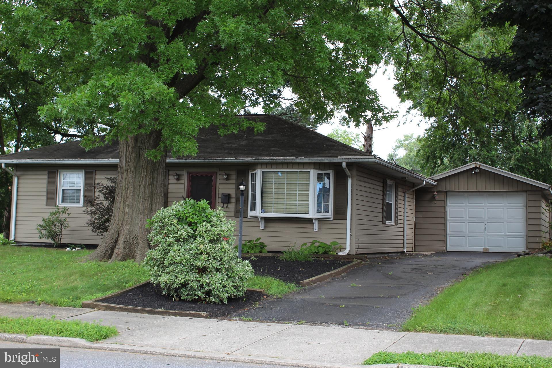 501 East New Street Lititz, PA 17543 - Photo 2 of 16 a front view of a house with a yard and potted plants