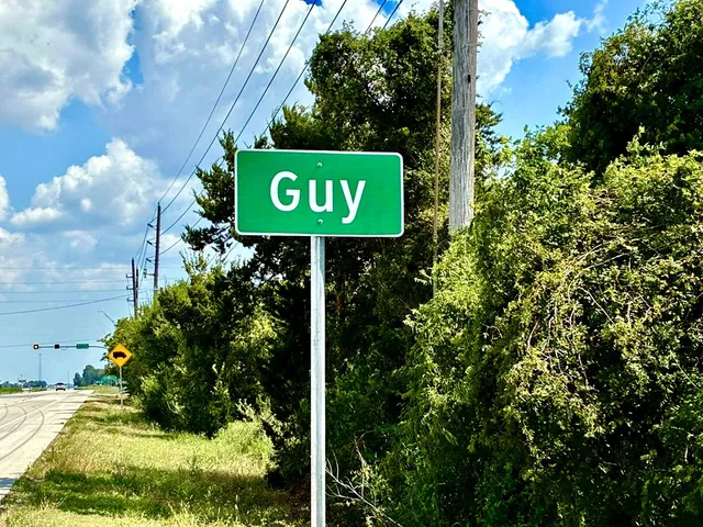 a sign broad in front of the tree