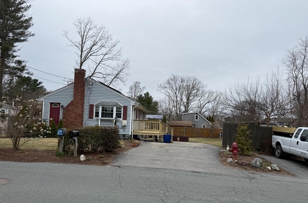 47 Summit Road Holbrook, MA 02343 - Photo 3 of 28 a front view of a house with a yard and garage