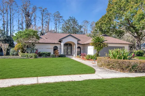 a front view of a house with a garden and plants
