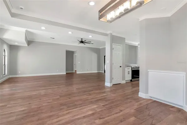 a large kitchen with kitchen island a stove a sink a center island and cabinets