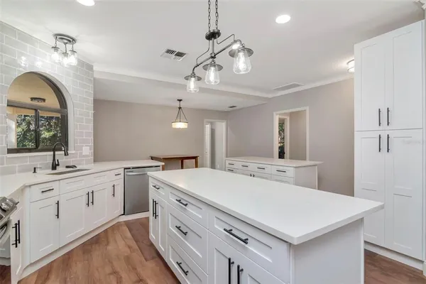 a kitchen that has a cabinets and wooden floor