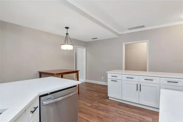 a view of an empty room and wooden floor