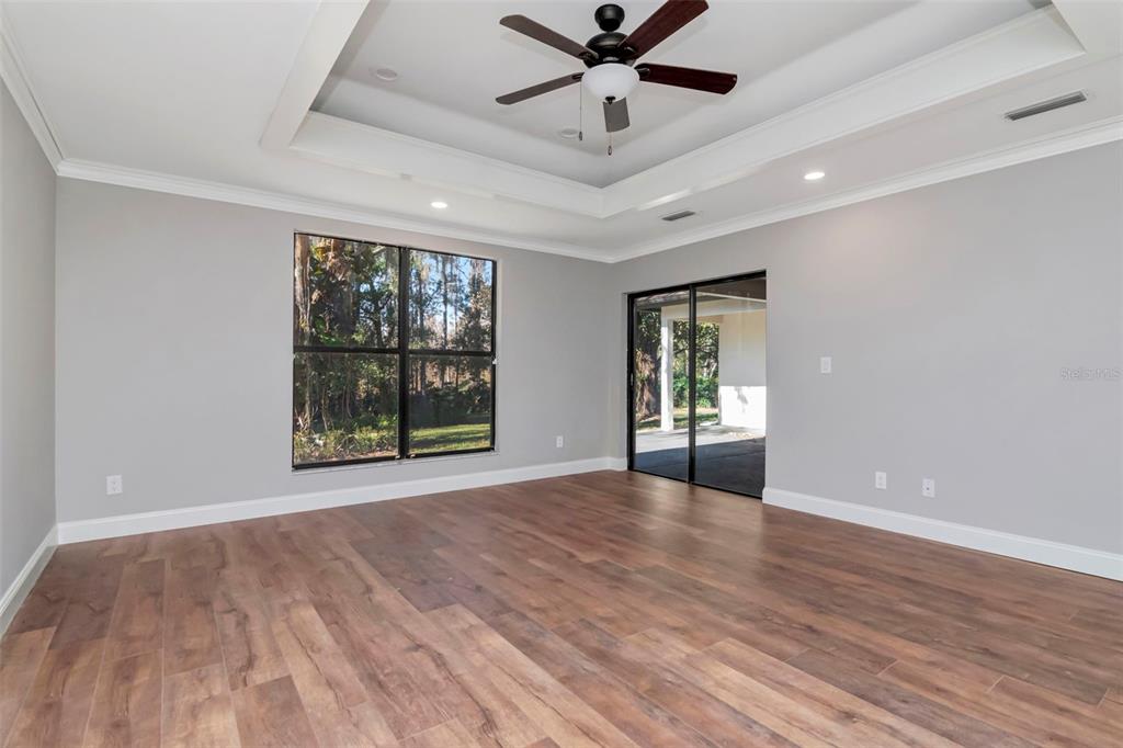 18306 Pleasant Ridge Place Lutz, FL 33548 - Photo 35 of 64 a view of an empty room with a window and wooden floor