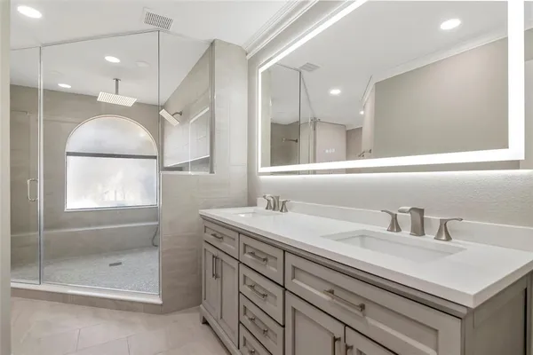 a bathroom with a toilet sink vanity and mirror