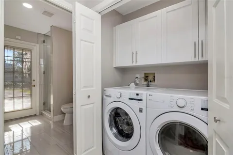 a view of a yard with plants and trees