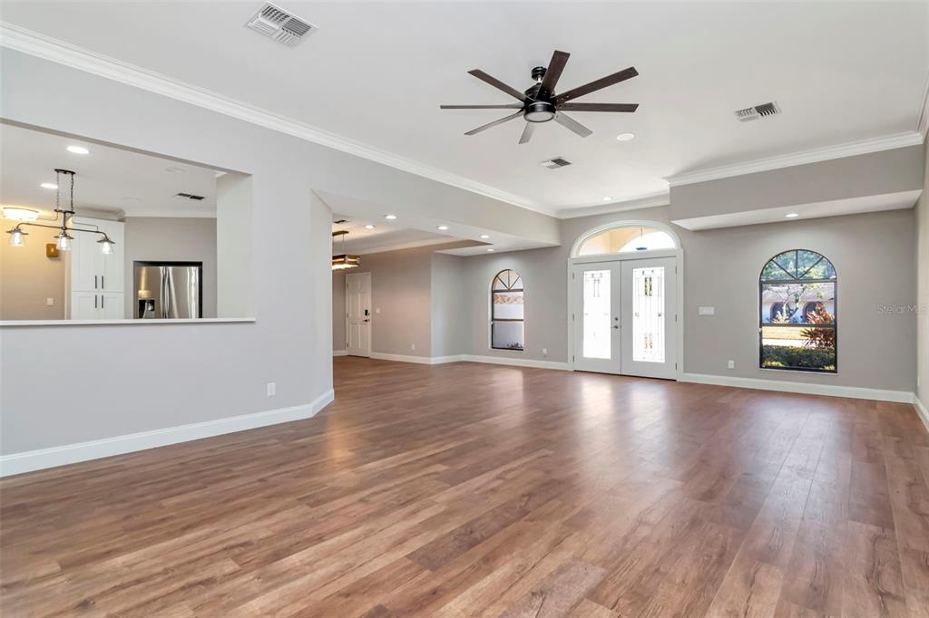 18306 Pleasant Ridge Place Lutz, FL 33548 - Photo 7 of 64 a view of an empty room with window and wooden floor