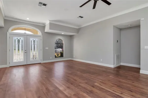 wooden floor in an empty room with a window