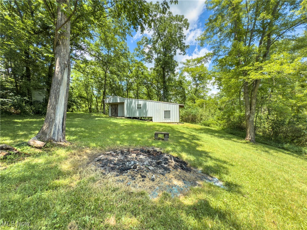 36475 Kinney Ridge Road Woodsfield, OH 43793 - Photo 32 of 50 View of grassy yard with an outbuilding and an outdoor structure