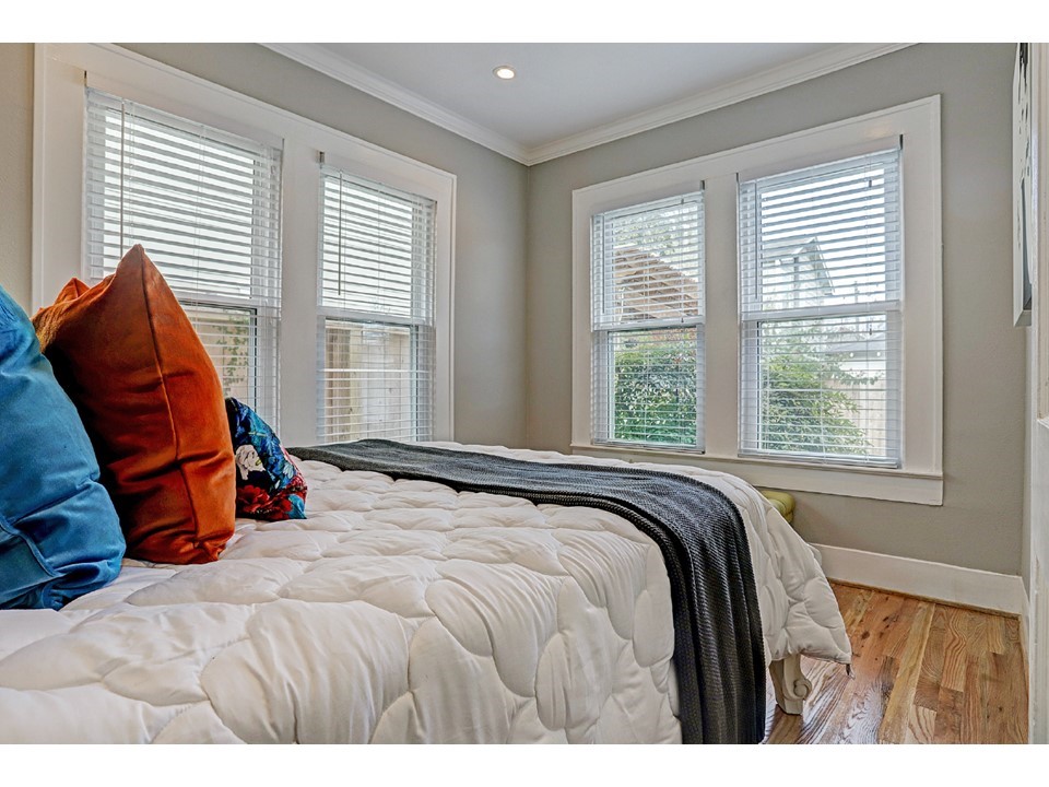 127 Payne Street Houston, TX 77009 - Photo 14 of 23 2 walls of windows in the bedroom that look onto the backyard.
