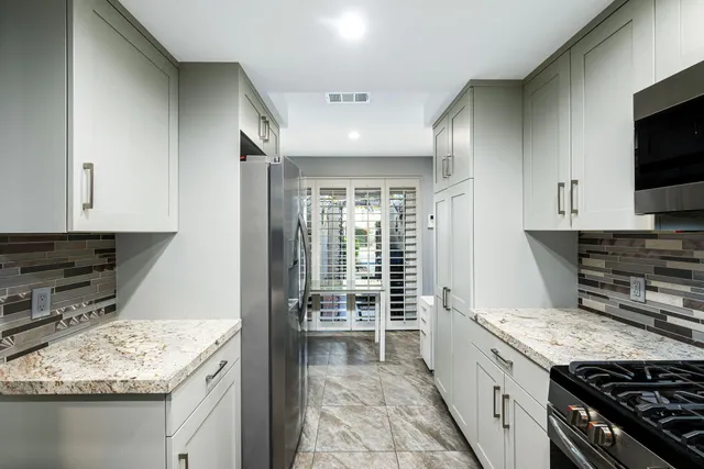 a kitchen with a refrigerator stove and a sink