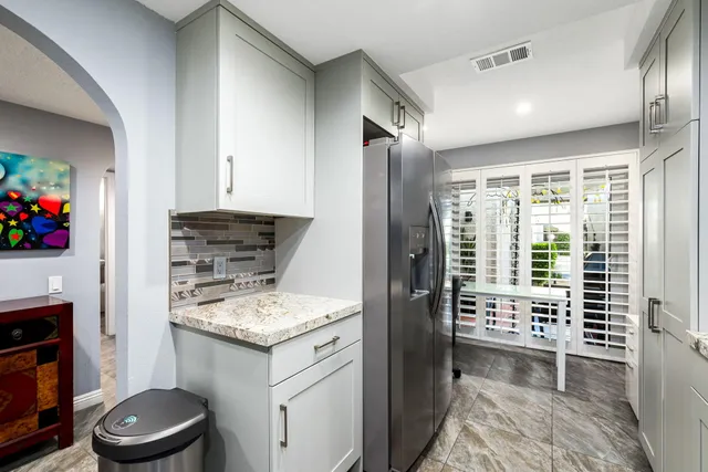 a kitchen with stainless steel appliances kitchen island granite countertop a sink stove and cabinets