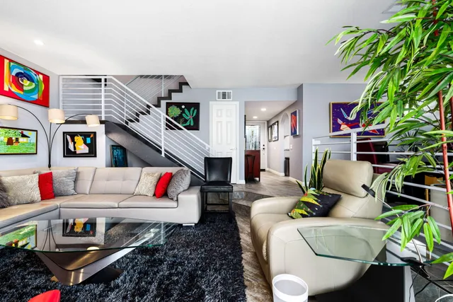 a living room with furniture and a potted plant