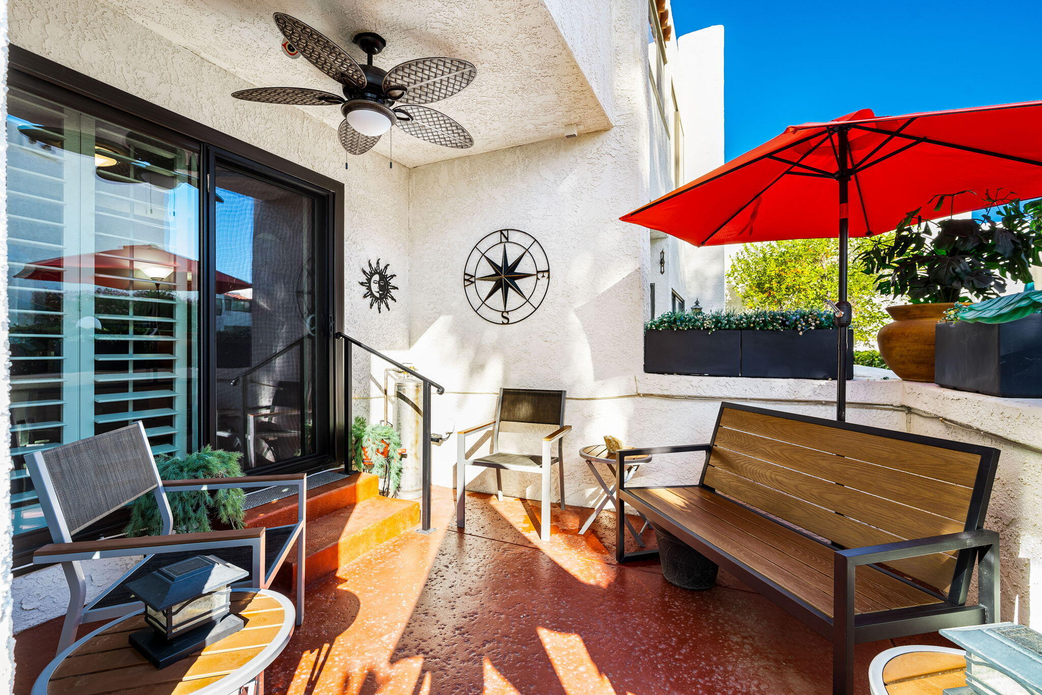 412 Rio Vista Drive Palm Springs, CA 92262 - Photo 23 of 45 a view of a patio with a table and chairs under an umbrella
