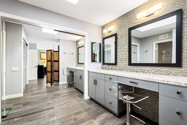 a living room with furniture and a flat screen tv with wooden floor