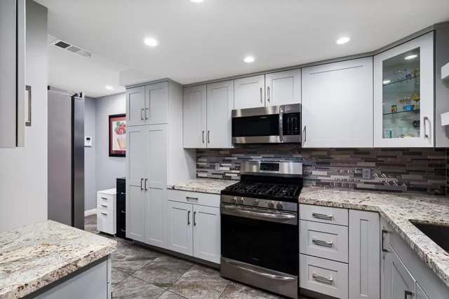 a kitchen with a sink stove and refrigerator