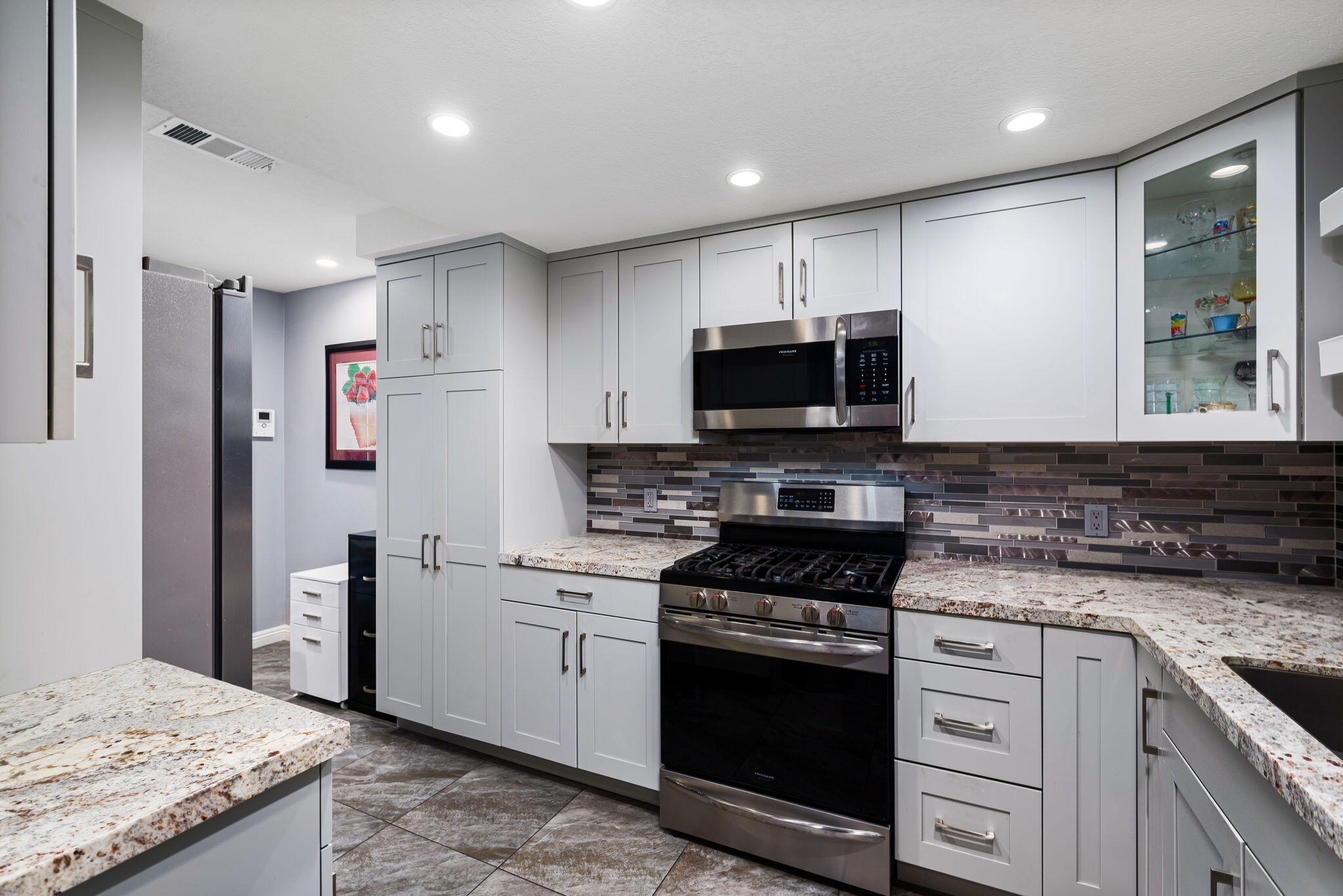 412 Rio Vista Drive Palm Springs, CA 92262 - Photo 5 of 45 a kitchen with a sink stove and refrigerator