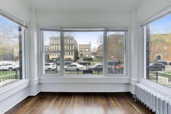 a room with wooden floor and a window