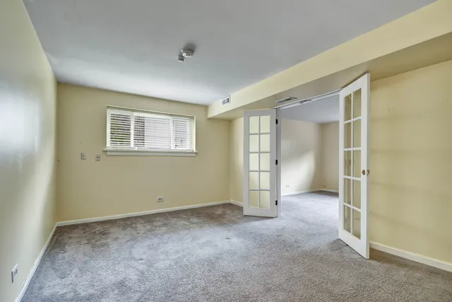 an empty room with windows and closet