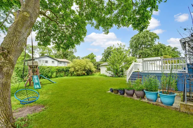 a view of a wooden deck with a yard