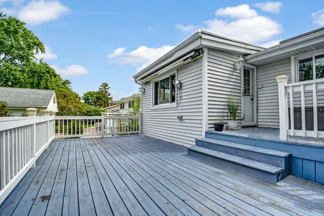 a view of a wooden deck and a yard