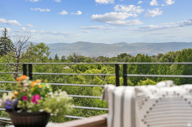 1400 Weber Wild Road Oakley, UT 84055 - Photo 26 of 55 Outdoor balcony featuring a metal railing system, lush green foliage, and distant mountain scenery