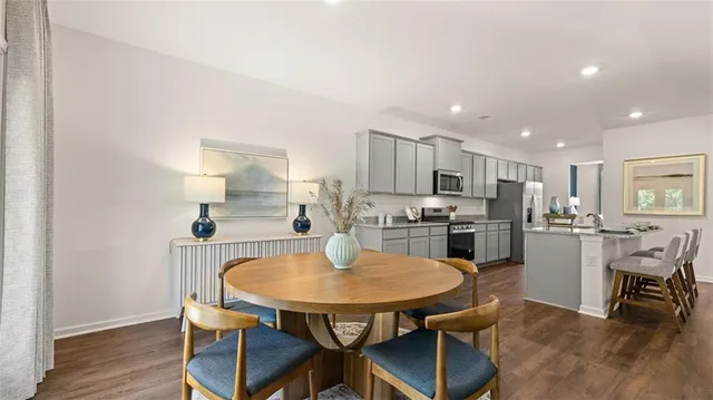 a living room with furniture wooden floor and a table
