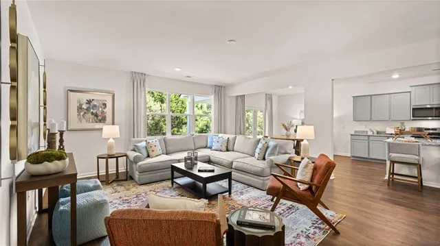 a spacious bedroom with furniture and a large window