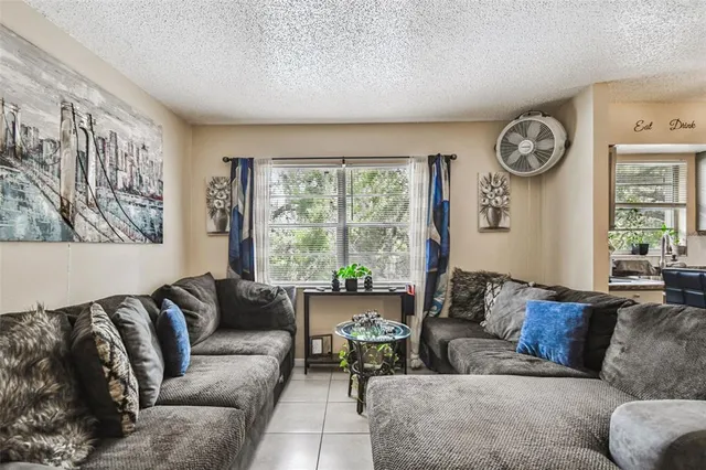 a living room with furniture and a large window