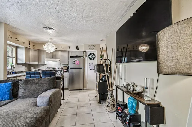 a kitchen with stainless steel appliances kitchen island granite countertop a refrigerator and a stove