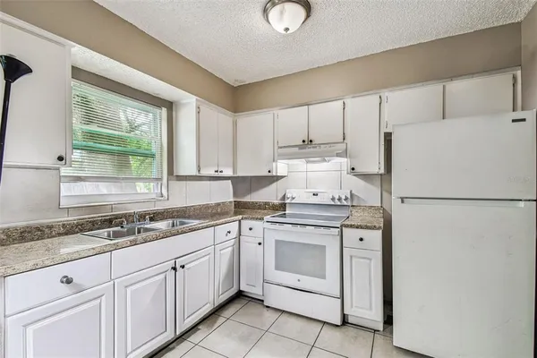 a kitchen with a white cabinets and white appliances