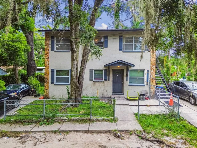 a front view of house with yard and green space