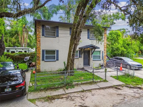 a front view of a house with a garden and plants