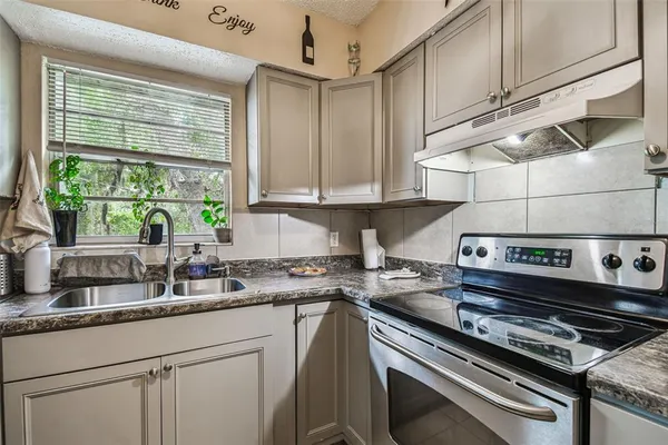 a kitchen with appliances cabinets and a sink