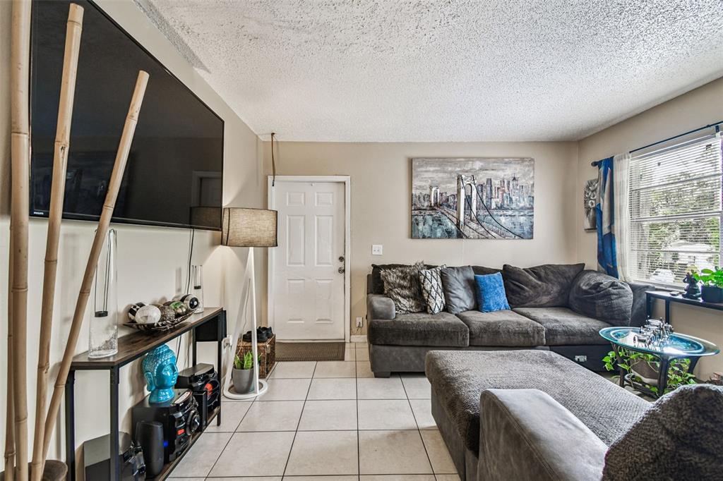 7902 North 14th Street Tampa, FL 33604 - Photo 10 of 25 a living room with furniture and a flat screen tv