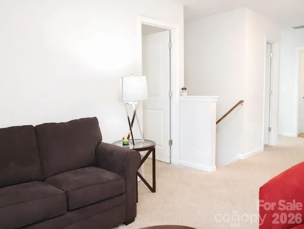 a living room with furniture and a lamp
