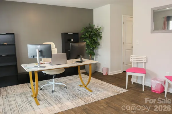a workspace with furniture and wooden floor